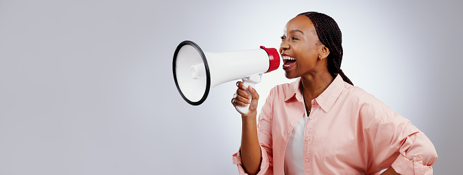 Happy woman, megaphone and voice for announcement, broadcast or news of sale or discount on white background. African person with attention, noise and broadcast of winner in studio and banner space