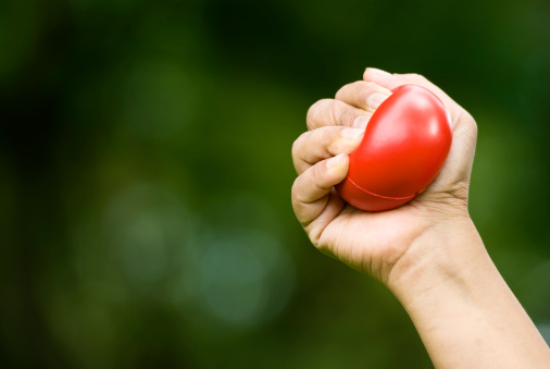 Hand squeezing a stress ball isolated on natural bokeh backgroundYou may also like these images related to stress ball: