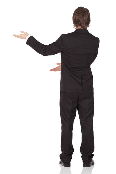 istock Rear view of a businessman gesturing 184998949