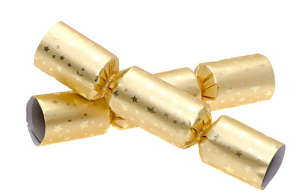 Two gold Christmas crackers - studio shot with a white background