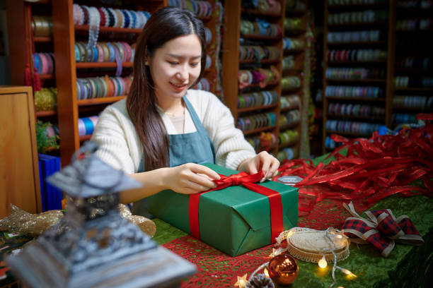 istock Side View of One Asia Female Wrapping Gift Box 1850000201