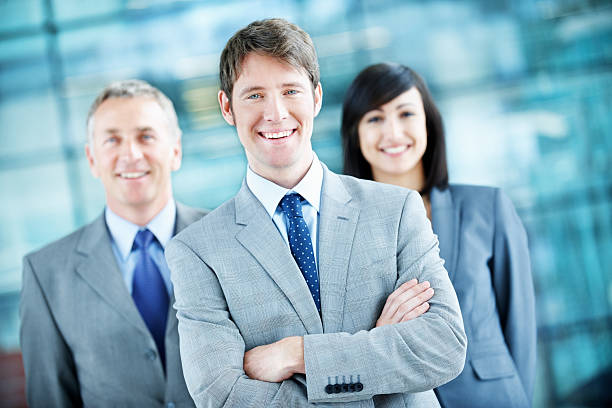 istock Young confident businessman with team 185000073