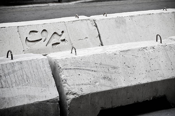 Concrete barriers in downtown Beirut, one of which has the word Beirut written in Arabic