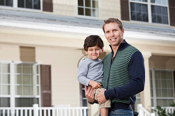 istock Little boy with father in front of house 185000317