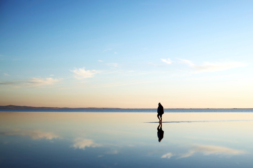 Old man walking on the salt lake.Scenic image offers copyspace available in istock only.
