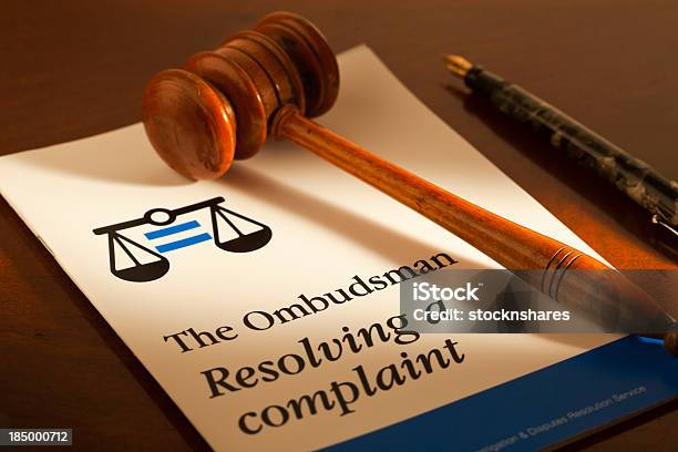 A Gavel And Pen Displayed With An Ombudsman Guidance Leaflet Stock Photo - Download Image Now
