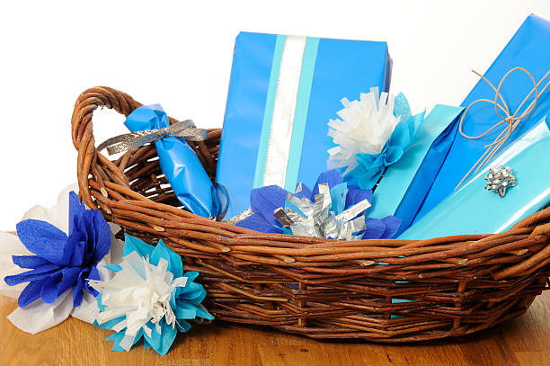 Wrapped presents in a cane basket. With flowers of colored paper.