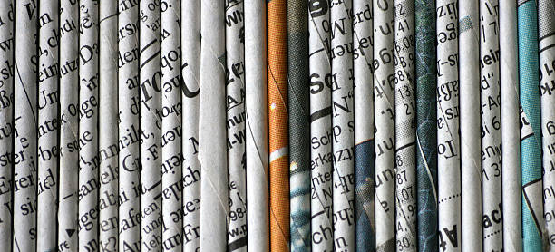 rolled newspaper pages stock photo