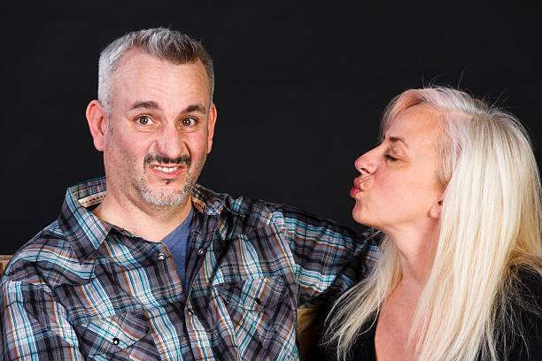 Man and Woman, Does She Really Want a Kiss A young woman wants a kiss but the young man is having second thoughts about whether of not to kiss her. men with hazel eyes stock pictures, royalty-free photos & images