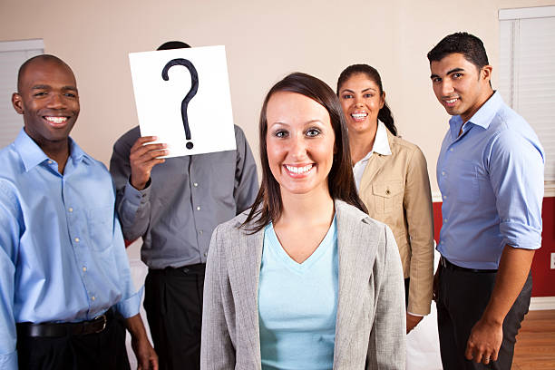 istock Mixed Ethnic Group of Young Adults with Question Mark Sign 185001177
