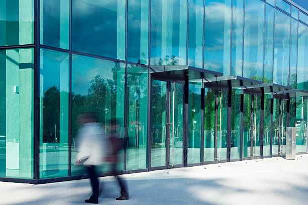 office worker walking in front of a modern business building,