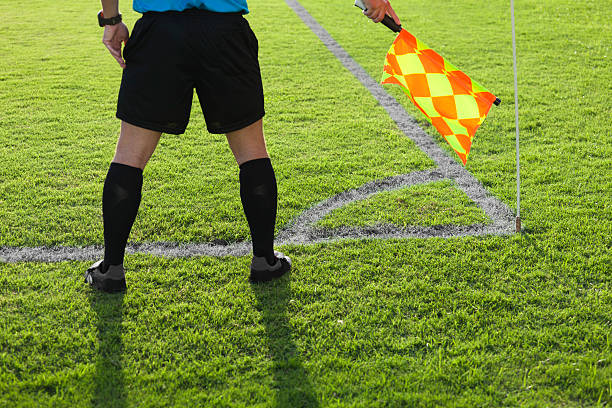 A football referee signs touchdown.