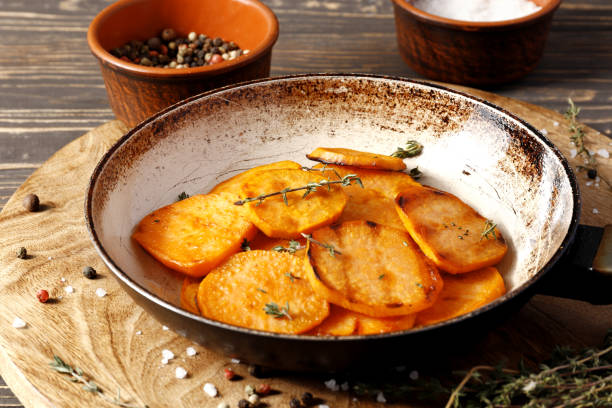 istock Frying pan with sweet fries on wooden table 1850020492