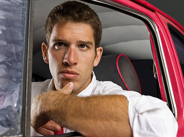 Thinking Man in Car Close-up portrait of contemplative businessman in car. rolled up sleeves stock pictures, royalty-free photos & images