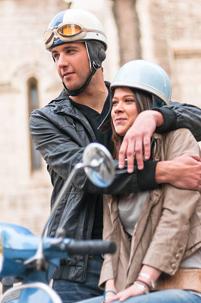 istock Guy and Girs Hugging on a Motor Scooter 185002282