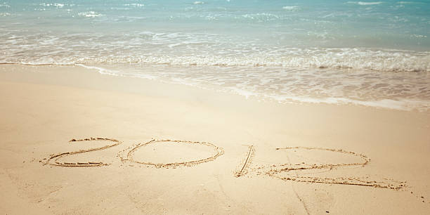 istock New year 2012 written in the sand beach 185002672
