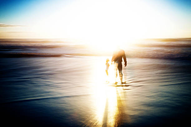 istock Father and daughter playing in the ocean 185002795