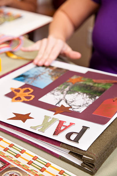 istock Lady scrapbooking, arranging images on the page. 185003009