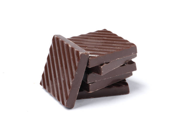 istock Black chocolate pieces isolated on a white background. 1850030526