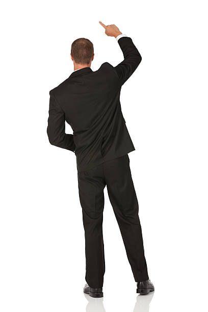 istock Rear view of a businessman pointing upward 185003140