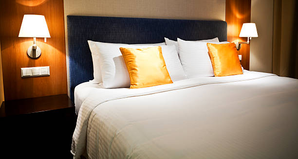 istock Orange and white luxury hotel room 185005026