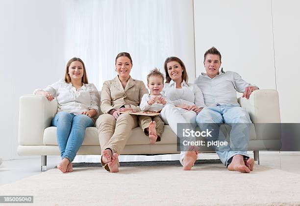 Family On Sofa Stock Photo - Download Image Now - 20-24 Years, Adult, Baby - Human Age