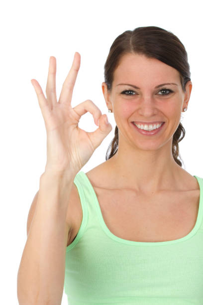 istock woman gesturing okay sign 185005171