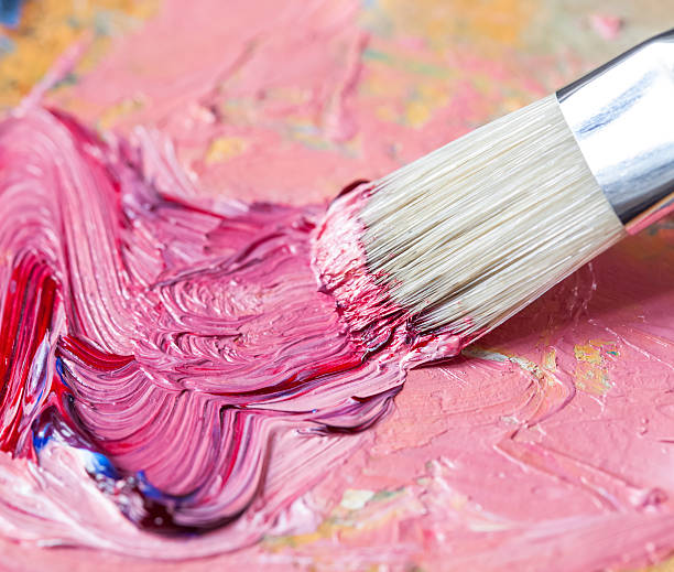 Paintbrush With Pink Oil Paint On A Classical Palette Stock Photo