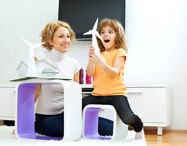 istock Mother and daughter playing with small windmill models 185005423