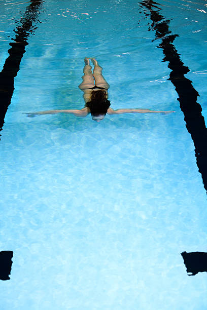 istock Young woman diving in swimming pool 185005534