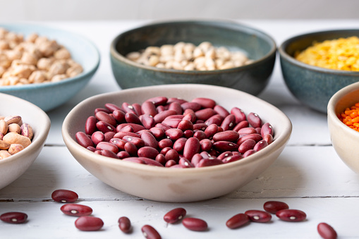 Different types of legumes in bowls - kidney beans
