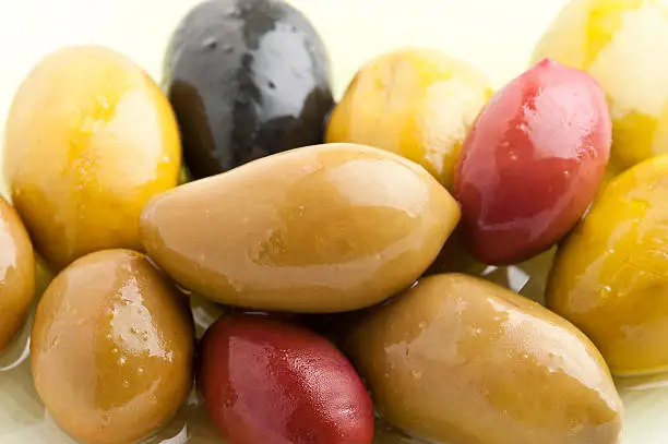 heap of assorted Cerignola Olives on white background