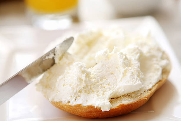 Half a bagel with cream cheese breakfast - bagel and cream cheese cream cheese photos stock pictures, royalty-free photos & images