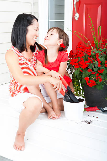 istock Mother and daughter laughing with each other while gardening 185007073