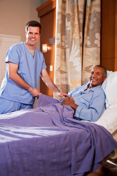 istock Hospital orderly assisting senior patient 185007472