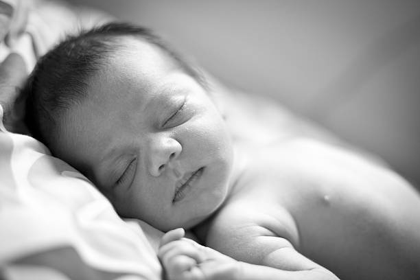 istock Close Up, Black and White Image of Newborn Sleeping 185007551