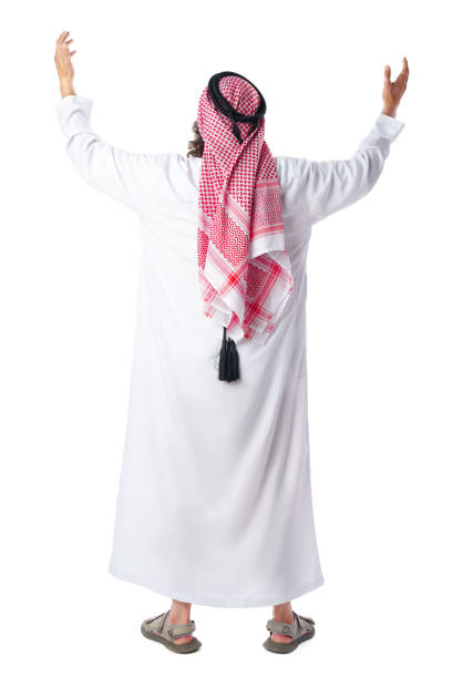 istock Back view of a man in thobe standing on white isolated background 1850076104