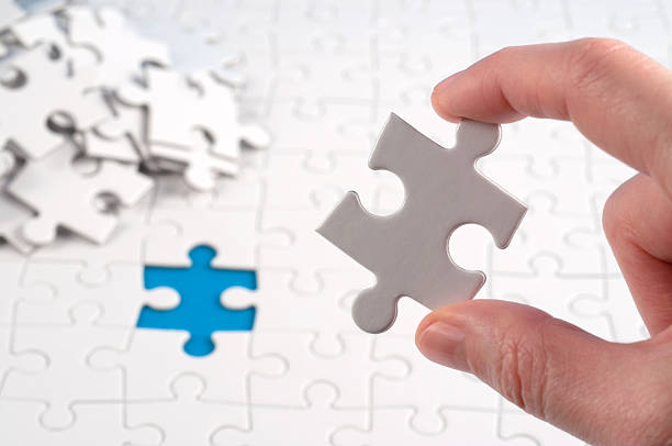 istock finishing the jigsaw 185007651