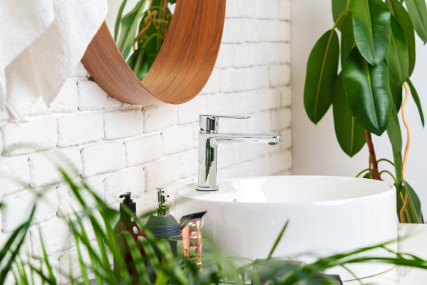 istock Bathroom interior with circle shaped mirror in wooden frame and white sink 1850079735