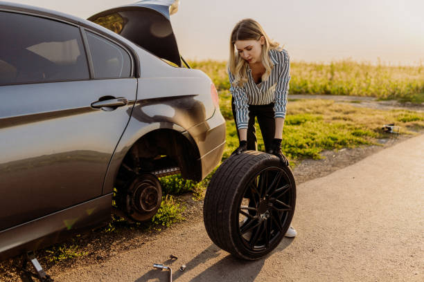 istock Woman changing tire 1850080261