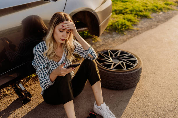istock Woman changing tire 1850080471