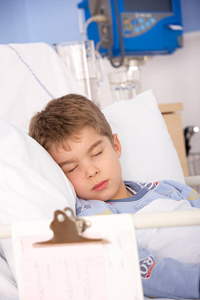 istock Young boy asleep in hospital bed 185008089