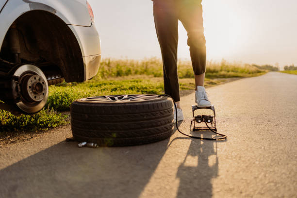 istock Woman changing tire 1850081343