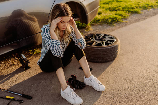 istock Woman changing tire 1850081345