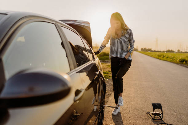 istock Woman changing tire 1850081504