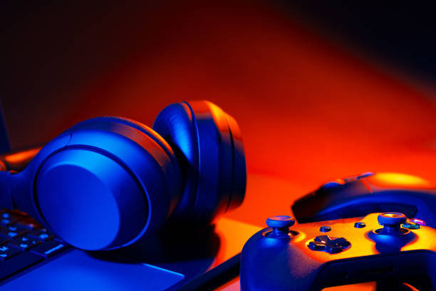 istock Headphones, joystick and computer keyboard on black table 1850081858