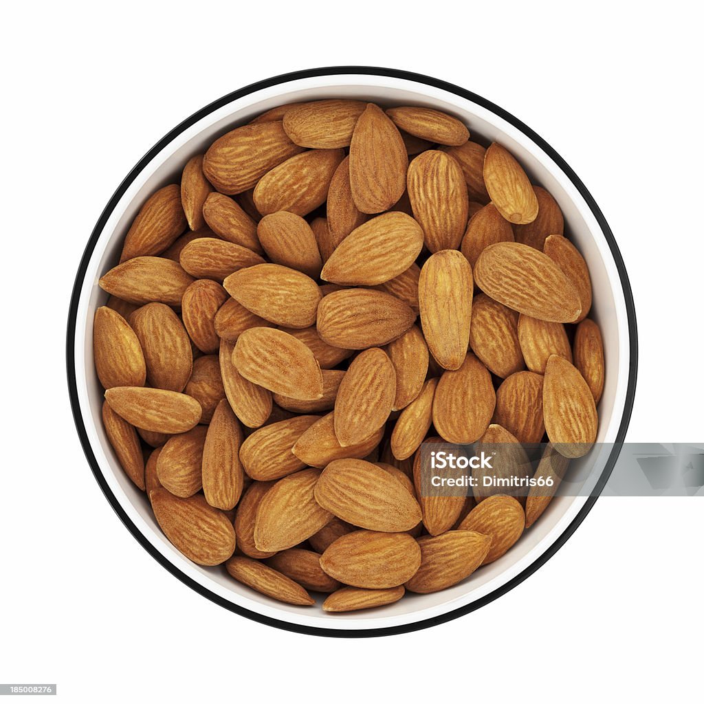 Almonds in a bowl from directly above "Shelled almonds in a circle bowl on white background, shot from directly above. Clipping path included.Almond pictures:" Almond Stock Photo