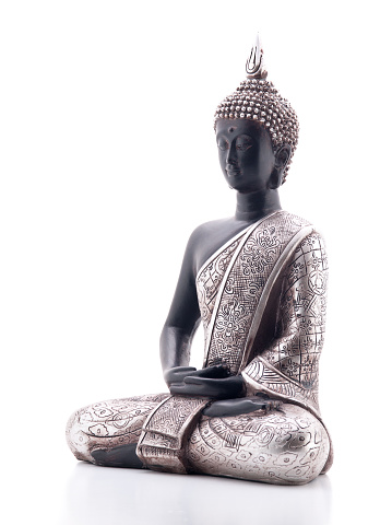 Statue of Buddha in lotus position, left view rotate 45º counterclockwise, isolated on white background, with reflection.