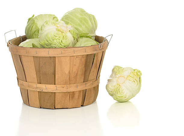 Green Cabbage in a Large Basket Green cabbage in a large wooden farm basket. basket healthy eating vegetarian food studio shot stock pictures, royalty-free photos & images