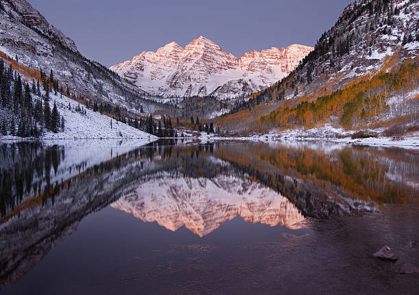 Maroon Bells Pre-Dawn Autumn Reflections "This image was taken approximately one half hour before sunrise to capture the pastel illumination that occurs before sunrise. The pre-dawn light gives the mountain sky a violet-blue color while the mountain snow reflects the soft glow of the pending sunrise. Calm waters also make for a mirror refleciton of the scene. Taken at Maroon Bells, near Aspen, Colorado." ice lakes colorado stock pictures, royalty-free photos & images